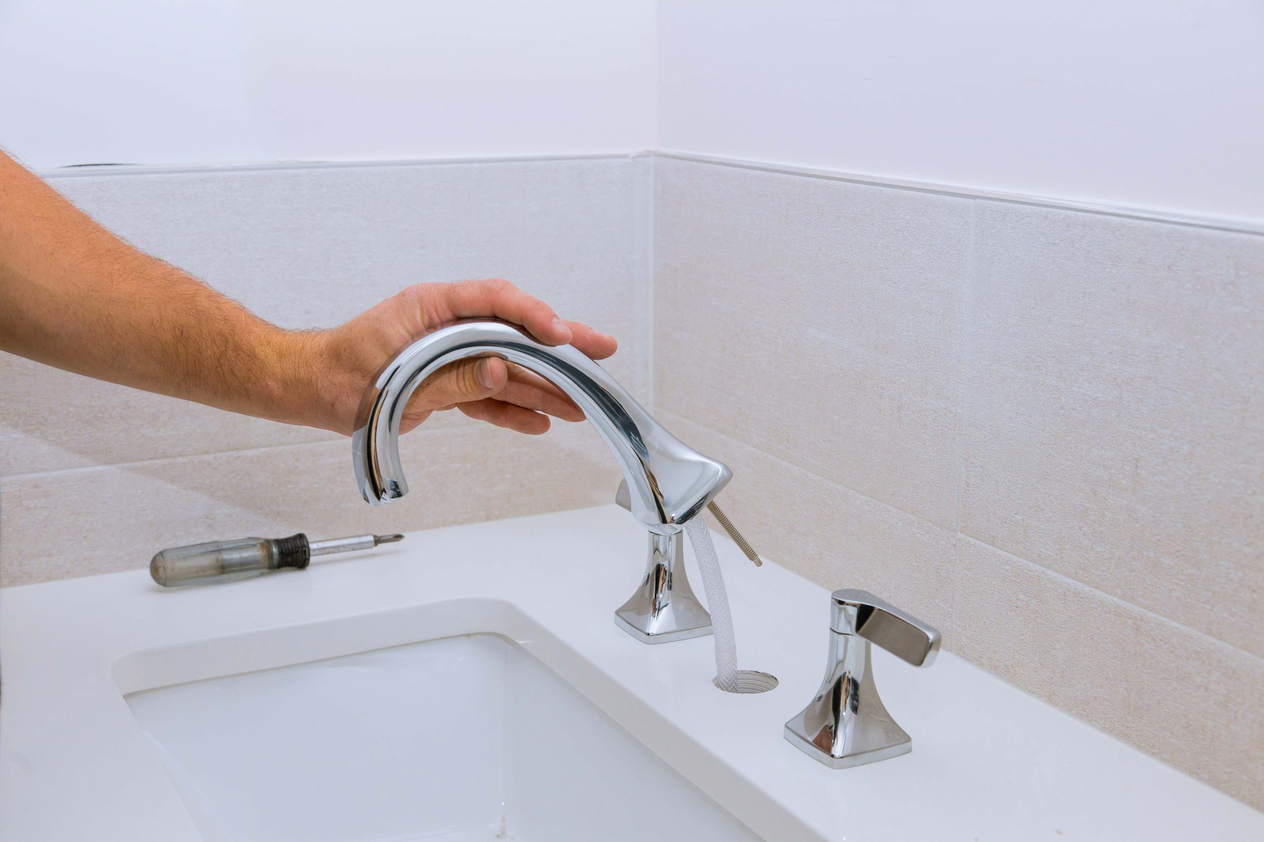 repair service, assemble new faucet lies on the ceramic sink