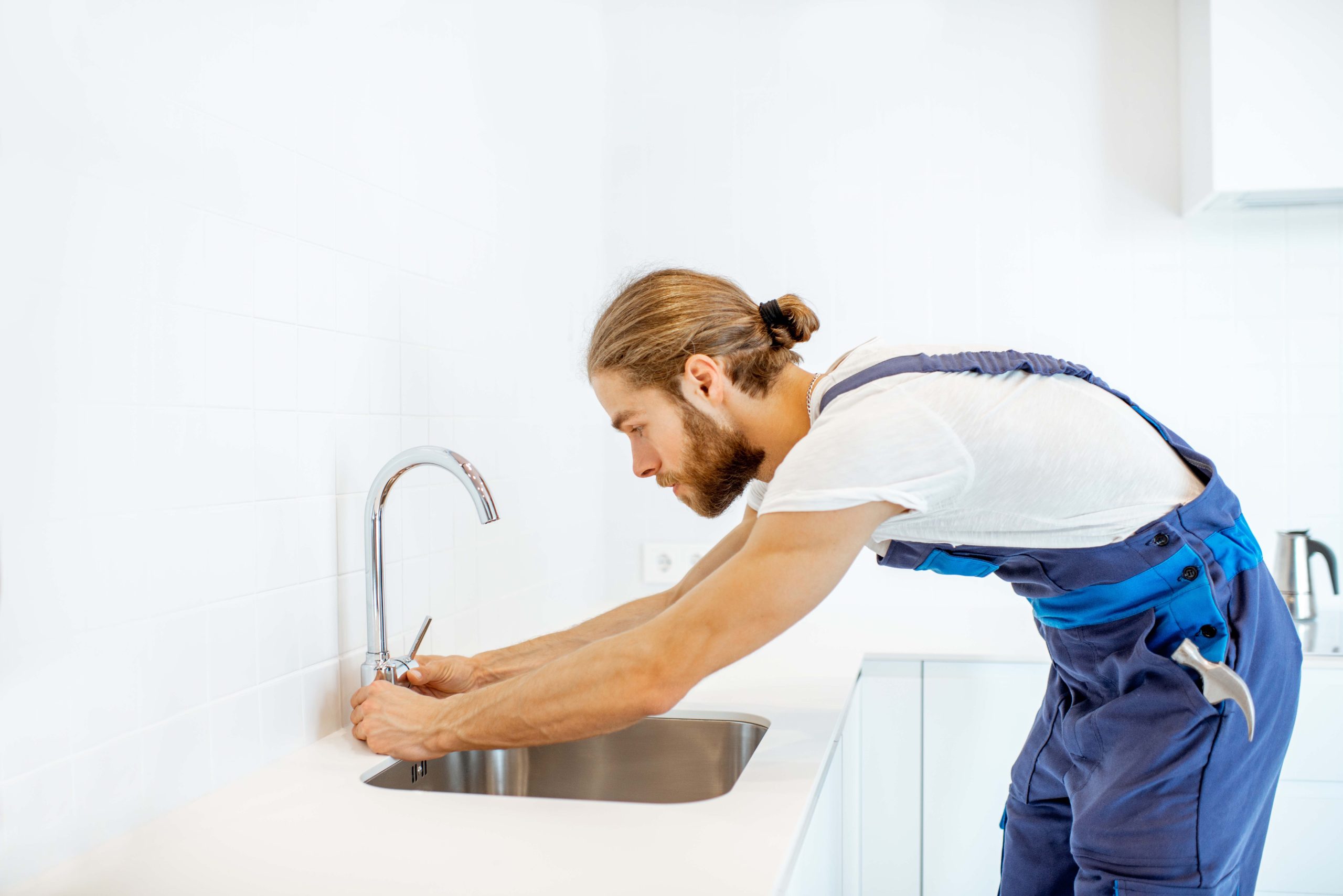 workman installing kitchen faucet